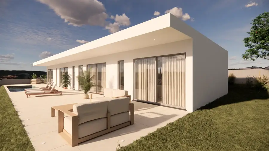 Exterior da moradia com relvado e árvores